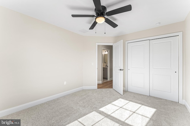 unfurnished bedroom with light colored carpet, baseboards, visible vents, and a closet