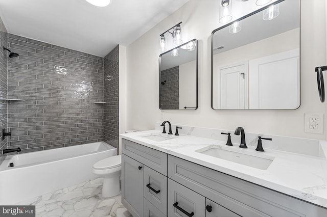 bathroom featuring double vanity, a sink, marble finish floor, and shower / bathtub combination