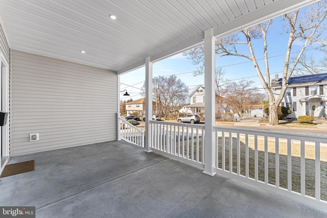 view of patio / terrace with a residential view and a porch