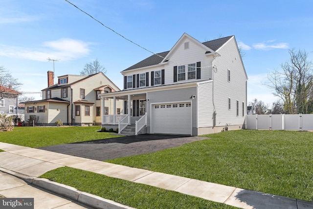 traditional-style home featuring aphalt driveway, fence, covered porch, a gate, and an attached garage