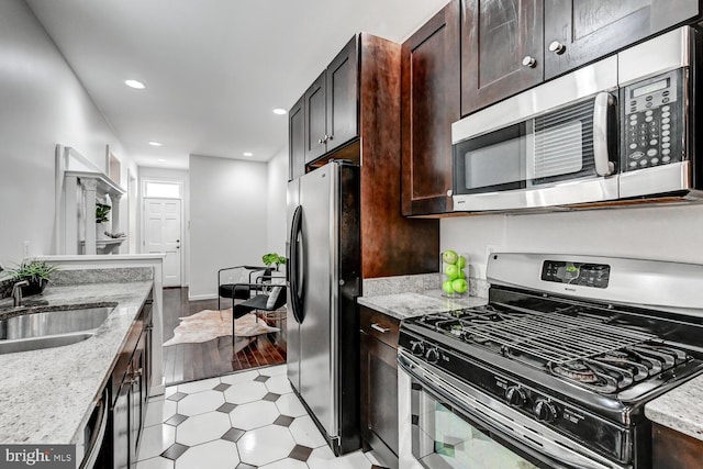 136 W Ostend St, Baltimore, MD 21230 - kitchen featuring appliances with stainless steel finishes, a sink, light flooring, dark brown cabinets, and recessed lighting