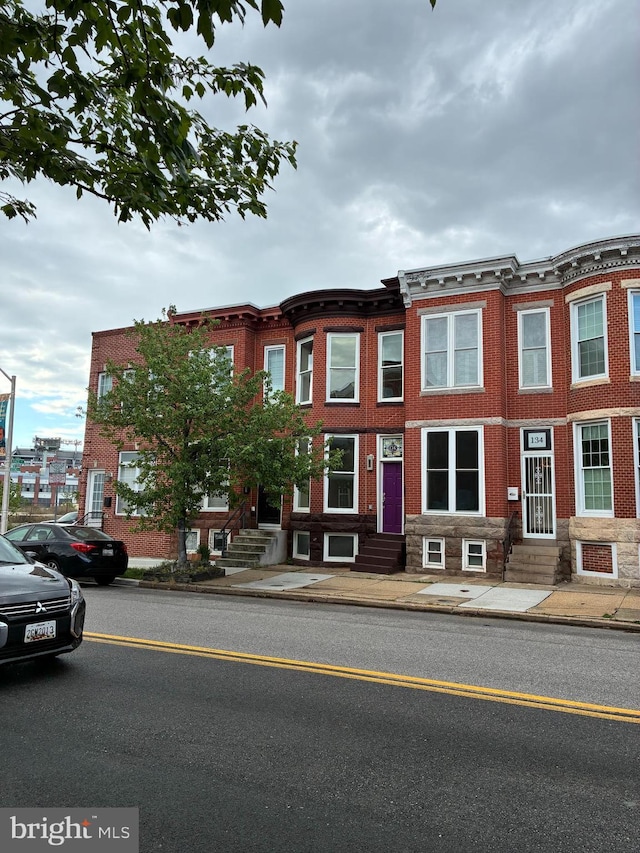 136 W Ostend St, Baltimore, MD 21230 - view of property with entry steps and brick siding