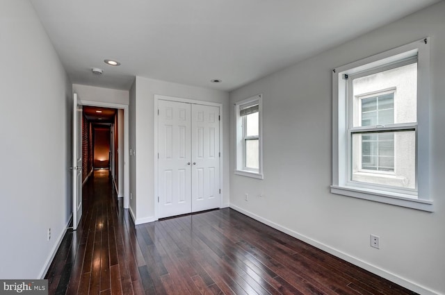136 W Ostend St, Baltimore, MD 21230 - unfurnished bedroom with baseboards, dark wood-type flooring, a closet, and recessed lighting