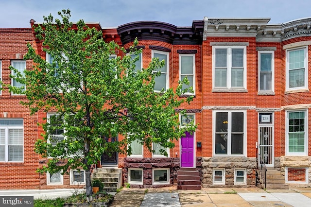 136 W Ostend St, Baltimore, MD 21230 - view of property with brick siding and entry steps
