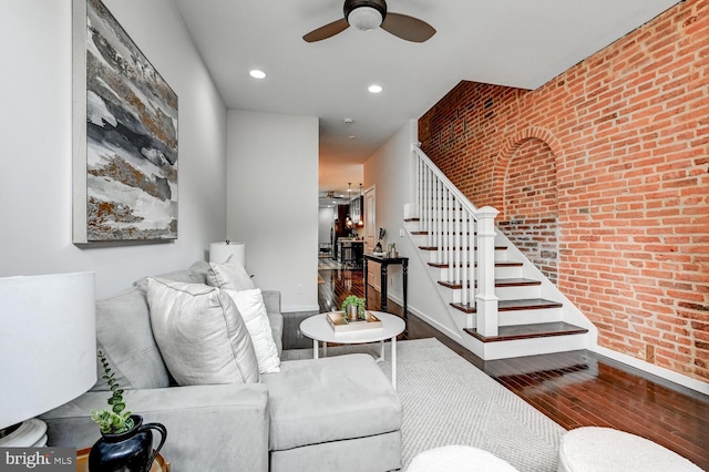 136 W Ostend St, Baltimore, MD 21230 - living room featuring a ceiling fan, hardwood / wood-style floors, brick wall, stairway, and baseboards
