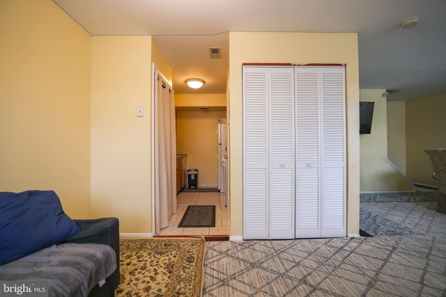 living area featuring light colored carpet and baseboards