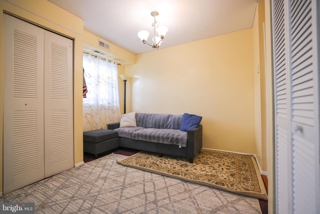 sitting room featuring visible vents, carpet flooring, baseboards, and a notable chandelier