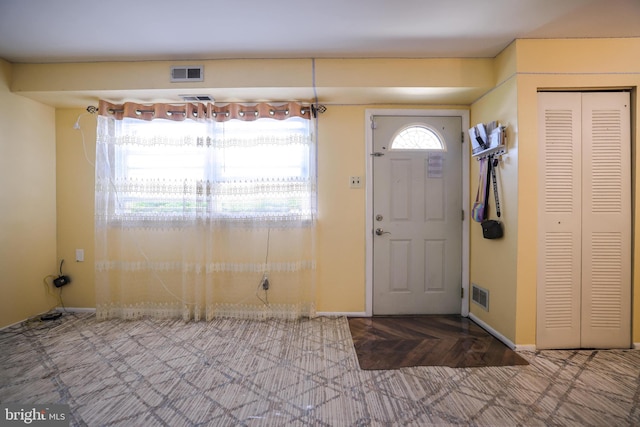 entryway with visible vents and baseboards