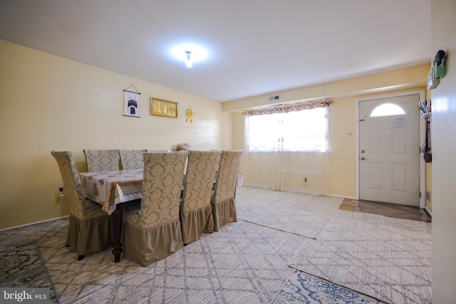 carpeted dining area with visible vents