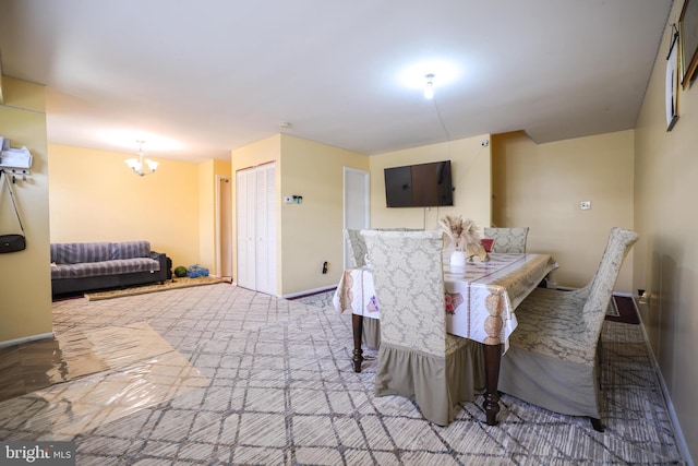 carpeted dining space featuring an inviting chandelier and baseboards