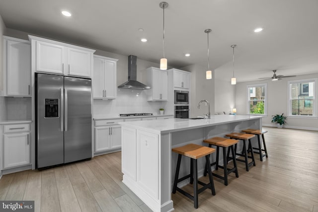 7410 Plainview Ter, Columbia, MD 21044 - kitchen with stainless steel appliances, wall chimney range hood, light wood finished floors, tasteful backsplash, and recessed lighting