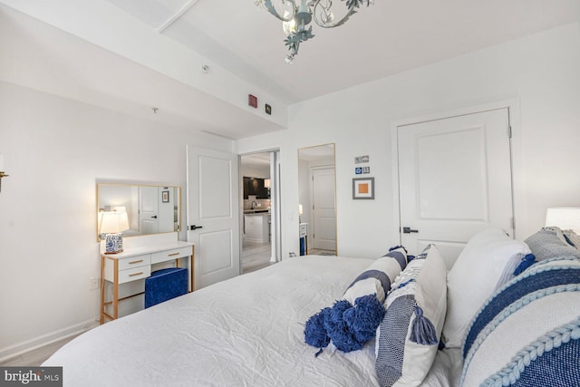 bedroom with baseboards, a sink, and wood finished floors