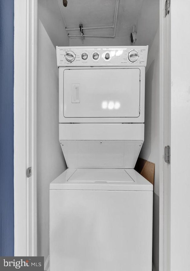 washroom featuring laundry area and stacked washer / dryer