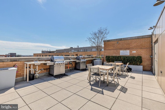 view of patio with outdoor dining space and a grill