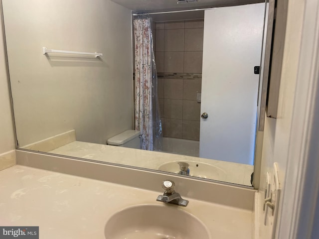bathroom with vanity, toilet, and shower / bath combination with curtain