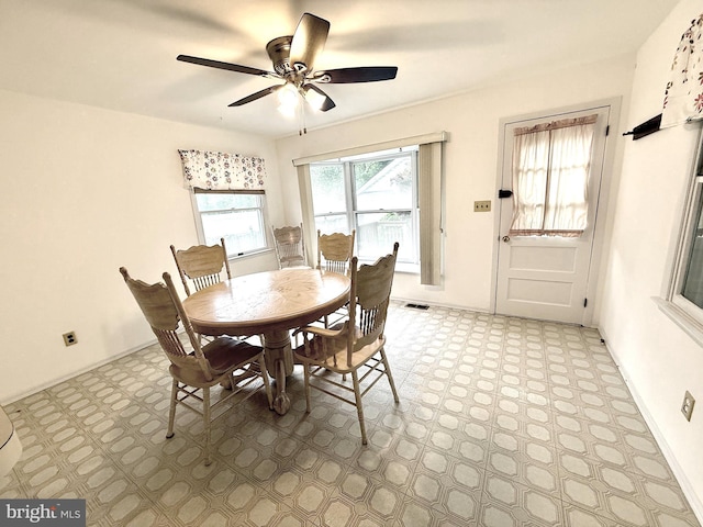dining space featuring light floors and ceiling fan