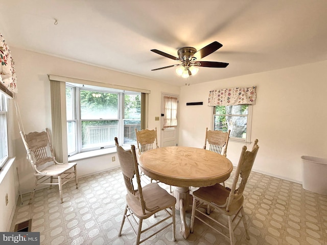 dining space with light floors, plenty of natural light, and ceiling fan