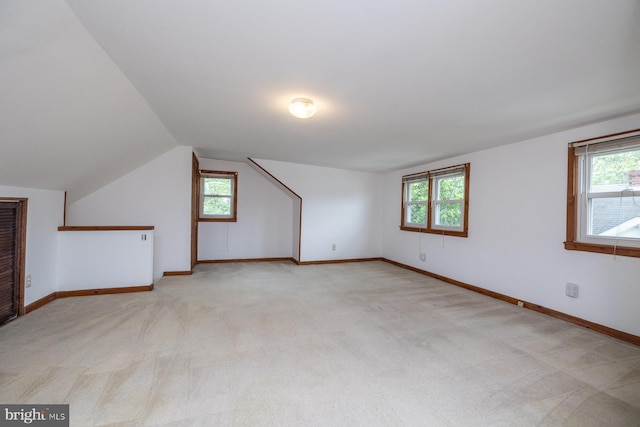 bonus room featuring light carpet and a healthy amount of sunlight
