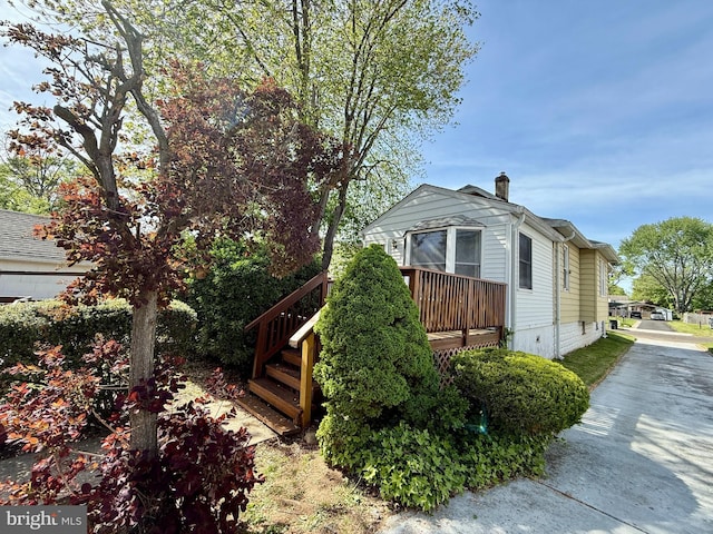 view of side of home featuring stairway
