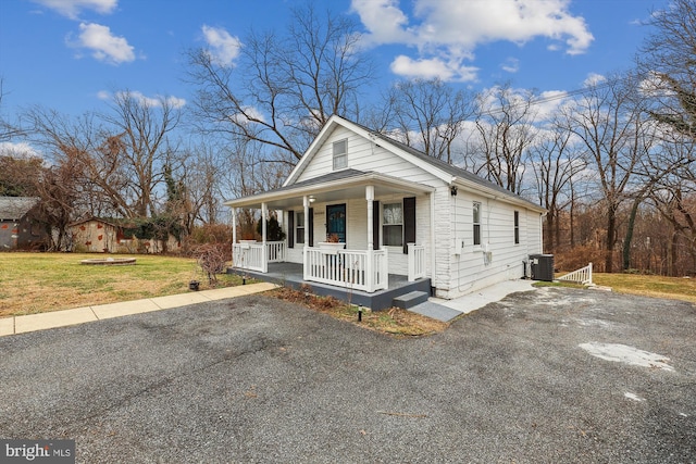 4527 Deer Park Dr, Temple Hills, MD 20748 - view of front of house featuring covered porch, a front lawn, and central air condition unit