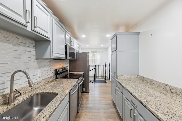 4527 Deer Park Dr, Temple Hills, MD 20748 - kitchen with gray cabinetry, appliances with stainless steel finishes, a sink, and wood finished floors