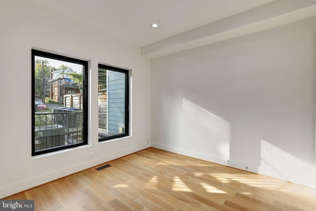 spare room with recessed lighting, baseboards, visible vents, and light wood finished floors