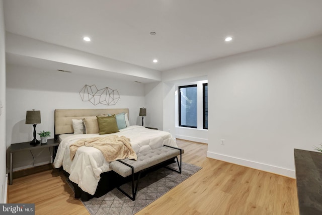 bedroom featuring recessed lighting, baseboards, and light wood-style flooring