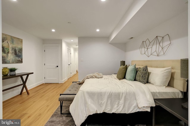 bedroom featuring recessed lighting, light wood finished floors, and baseboards