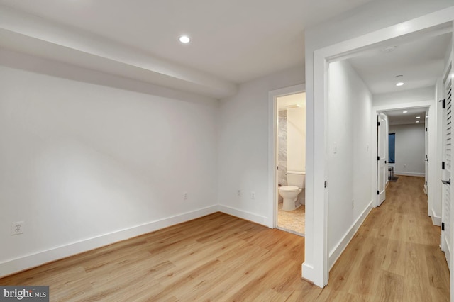 unfurnished bedroom with recessed lighting, baseboards, and light wood-type flooring