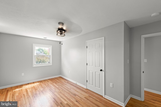 unfurnished bedroom with baseboards, a ceiling fan, and wood finished floors