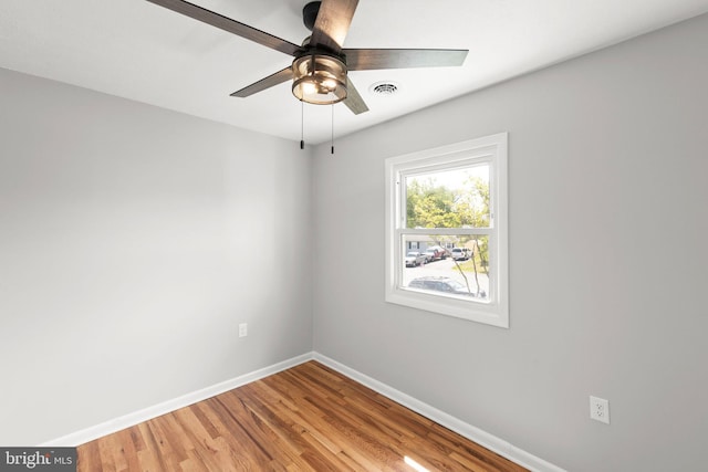 spare room featuring ceiling fan, baseboards, visible vents, and light wood-style flooring