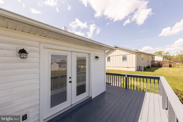 deck featuring a lawn, french doors, and central air condition unit