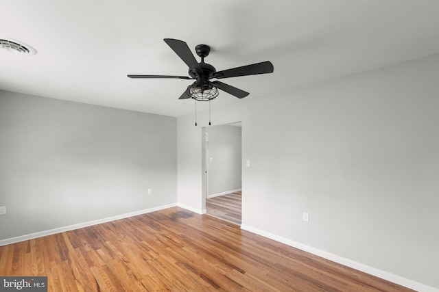 unfurnished room with baseboards, ceiling fan, light wood-type flooring, and visible vents