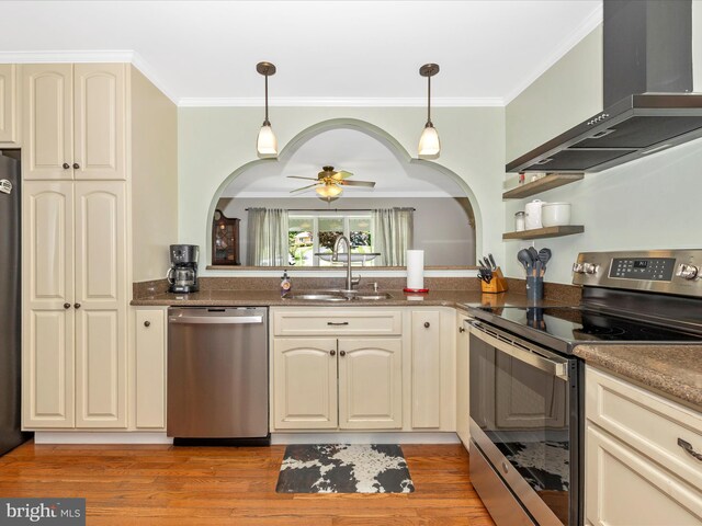 7214 Honeybush Dr, Mount Airy, MD 21771 - kitchen featuring appliances with stainless steel finishes, wall chimney exhaust hood, a sink, hanging light fixtures, and ornamental molding
