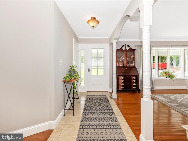 7214 Honeybush Dr, Mount Airy, MD 21771 - foyer with healthy amount of natural light, light tile patterned floors, ornate columns, baseboards, and crown molding