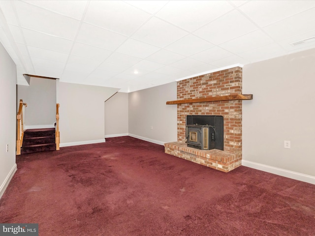 7214 Honeybush Dr, Mount Airy, MD 21771 - unfurnished living room featuring carpet flooring, stairs, a wood stove, baseboards, and a paneled ceiling