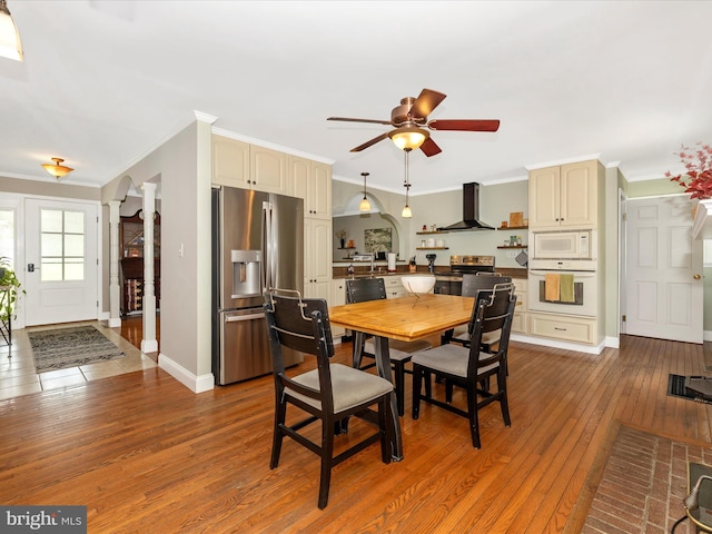 7214 Honeybush Dr, Mount Airy, MD 21771 - dining area with hardwood / wood-style floors, a ceiling fan, crown molding, baseboards, and decorative columns