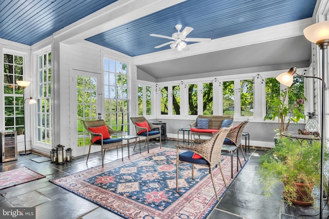 sunroom with french doors, baseboards, a wealth of natural light, and beverage cooler