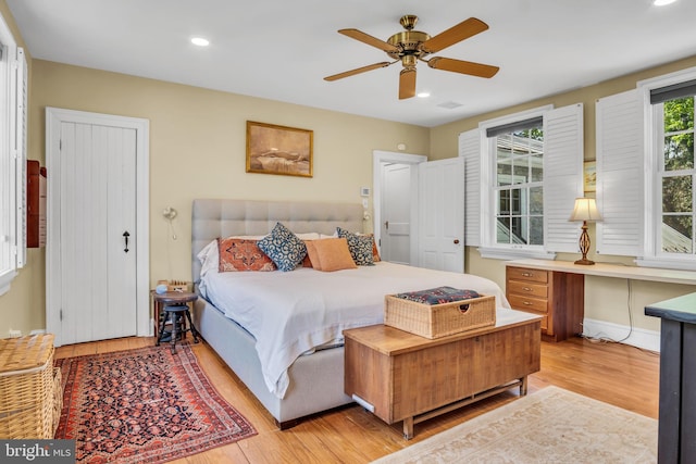 bedroom with recessed lighting, ceiling fan, light wood finished floors, and visible vents