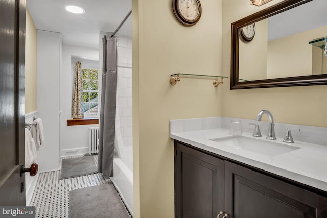 full bath with tile patterned floors, shower / bath combination with curtain, radiator, and vanity
