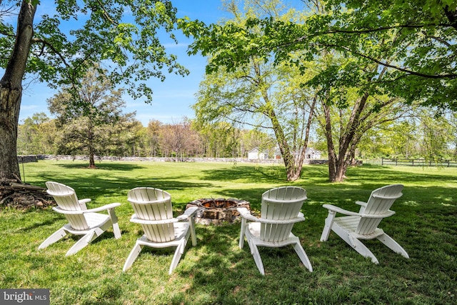 view of yard featuring fence and a fire pit