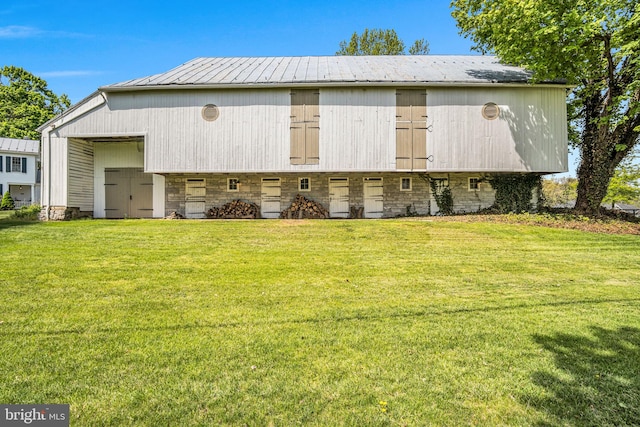back of property with a lawn and metal roof