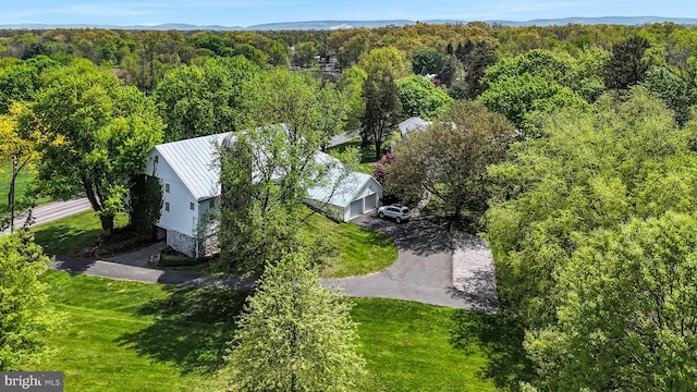birds eye view of property featuring a view of trees