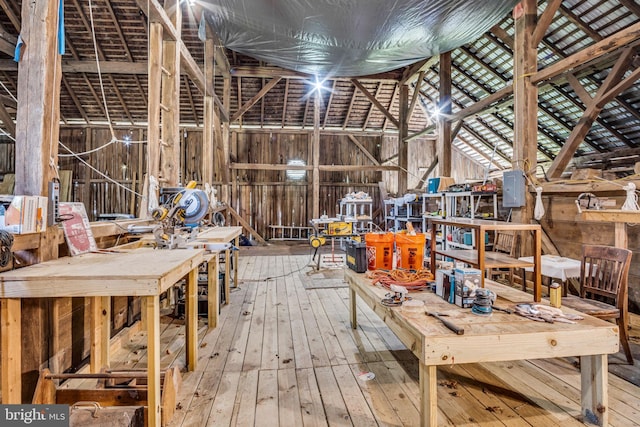 misc room with hardwood / wood-style floors and a workshop area