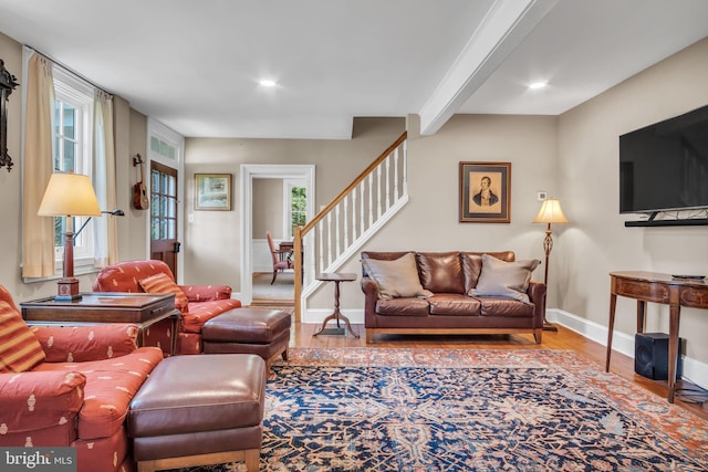 living area featuring recessed lighting, baseboards, wood finished floors, and stairway