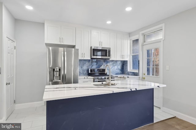 6227 Delancey St, Philadelphia, PA 19143 - kitchen featuring light countertops, appliances with stainless steel finishes, decorative backsplash, and baseboards