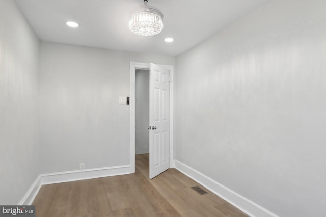 6227 Delancey St, Philadelphia, PA 19143 - empty room with baseboards, a notable chandelier, wood finished floors, and visible vents