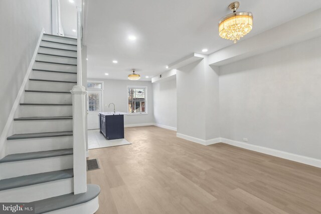 6227 Delancey St, Philadelphia, PA 19143 - stairs featuring visible vents, wood finished floors, baseboards, recessed lighting, and a chandelier