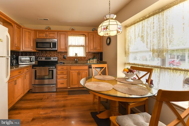 102 Lakebridge Dr, Deptford, NJ 08096 - kitchen with decorative backsplash, visible vents, brown cabinets, a sink, and stainless steel appliances
