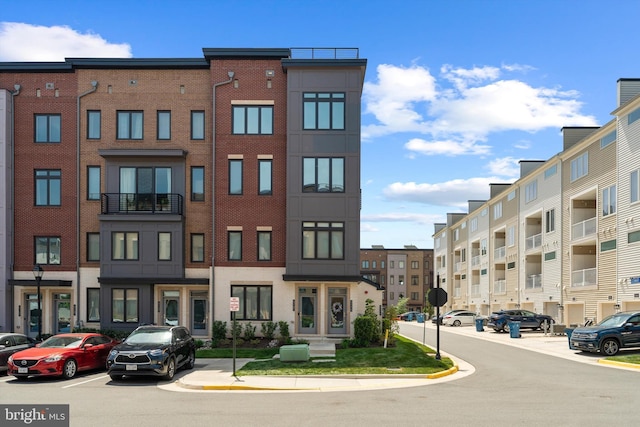 view of building exterior with uncovered parking